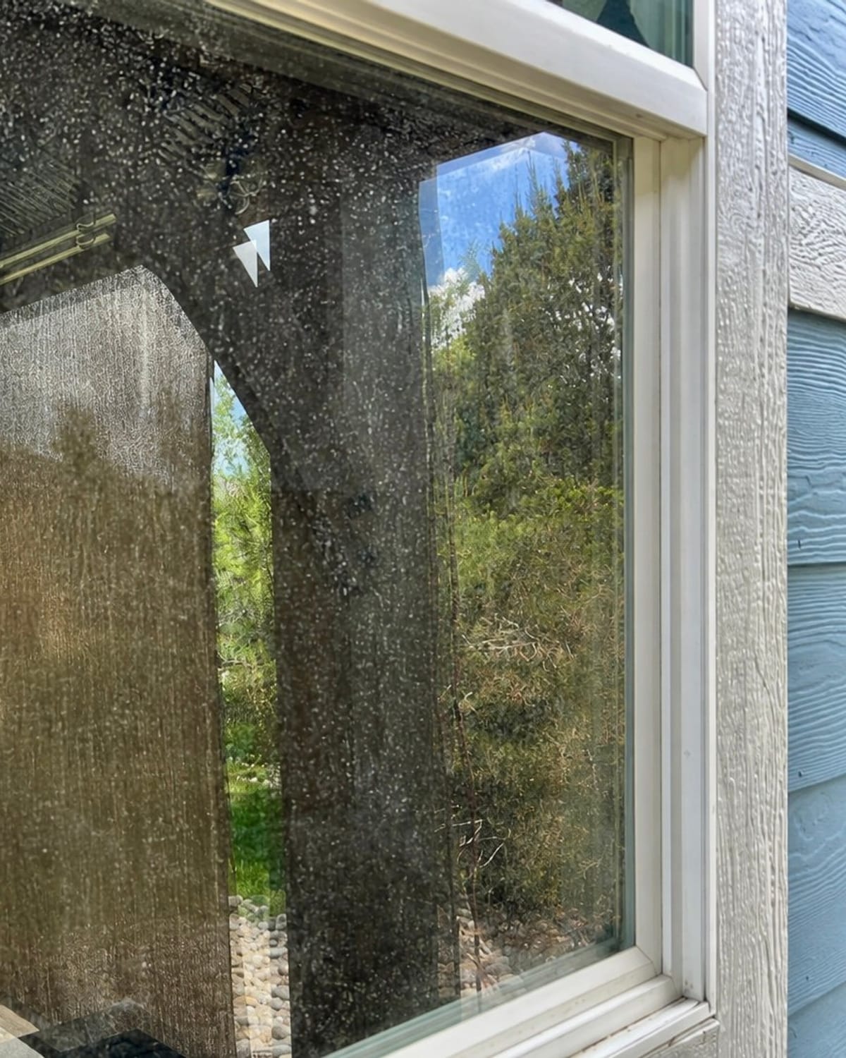 A Parker-area window covered in dust and hard-water spots before cleaning