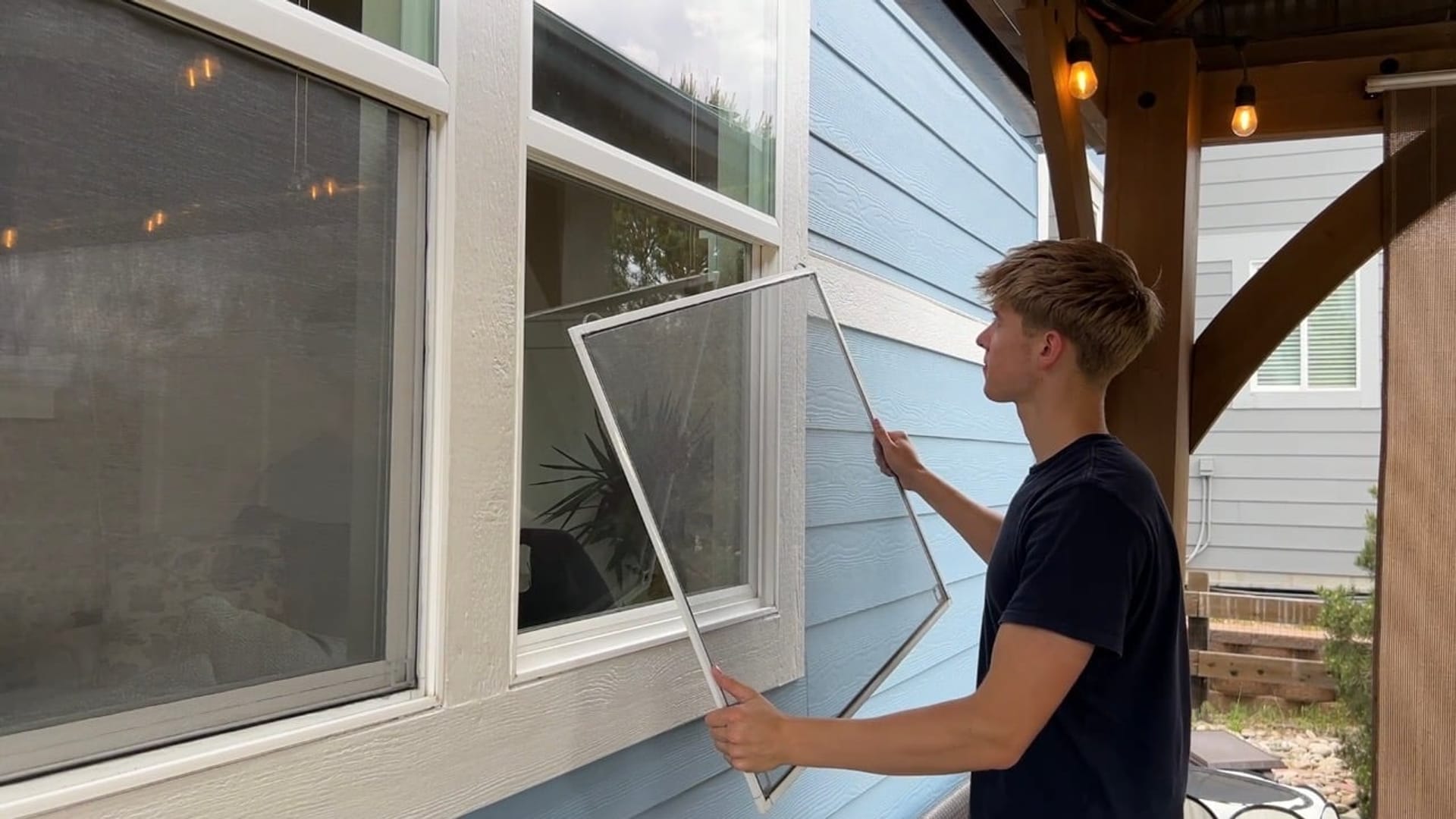 Butler's ClearView crew member repairing a window screen